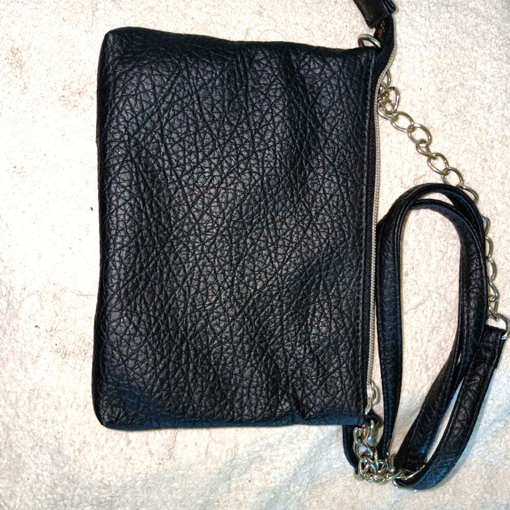 Women's crossbody leather purse never used in black with chain strap.
